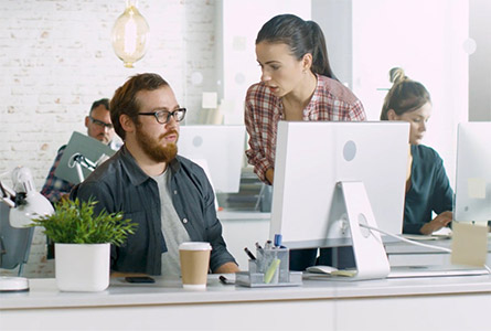 coworkers discussing something in front of a computer