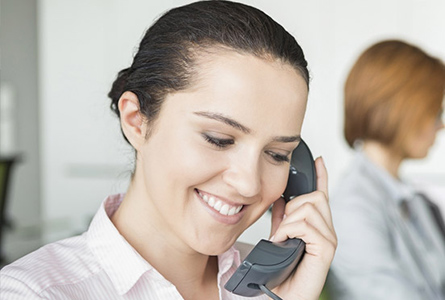 smiling woman talking on phone