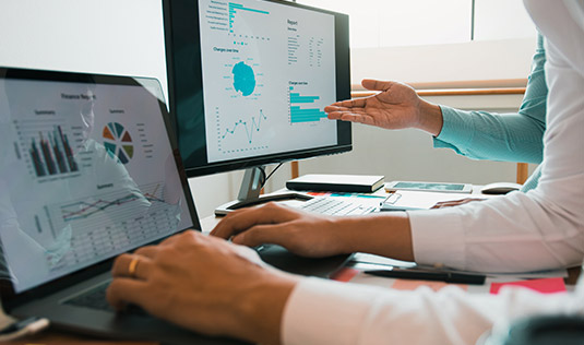 close up of computer screens with charts on them