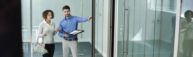 man and woman touring an office space