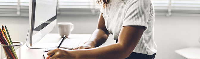 A entrepreneur takes notes during the year-end audit of their business website.