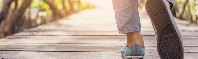 Closeup of the shoes of a person taking a relaxing stroll.