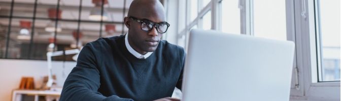 Businessman working on his laptop in an office