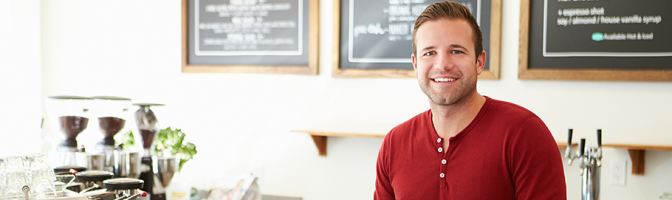 coffee shop worker or owner standing at digital cash register