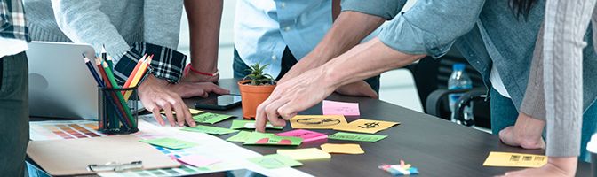 A group of professionals discussing strategy for growth in small business.