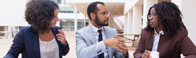 A group of business professionals having a discussion at a table.