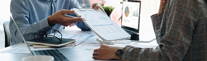Two small business partners discuss a growth strategy for their startup company.