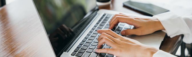 hands typing on laptop