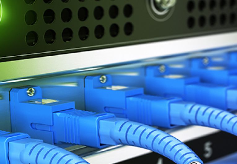 Multiple fiber optic cables plugged into an enterprise router