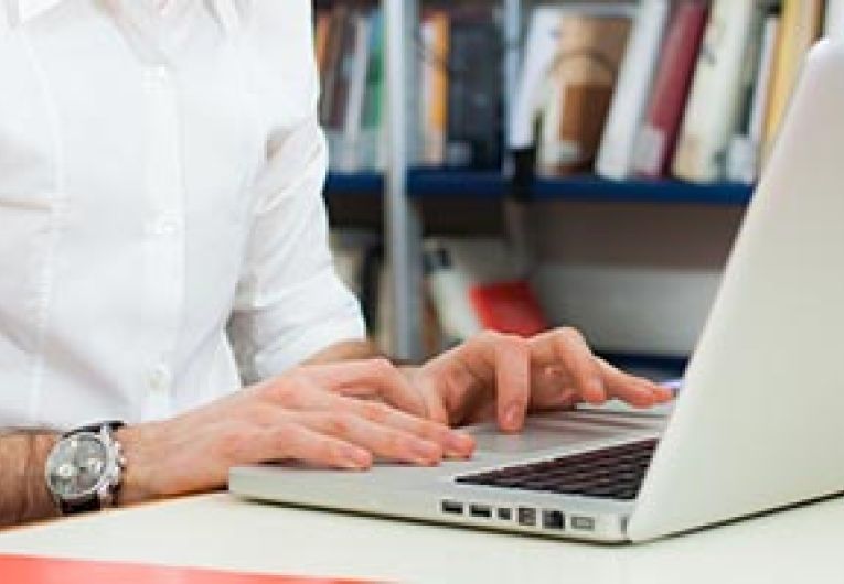 Person using laptop in library