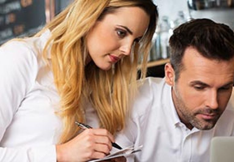 Man and woman looking at laptop