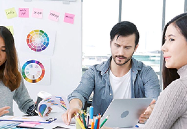 A small business team discusses data results during a meeting.