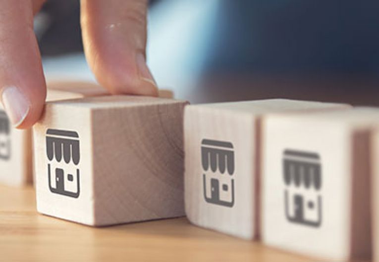 close up of someone arranging wooden blocks