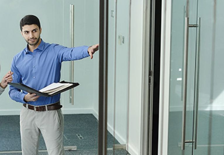 man and woman touring an office space