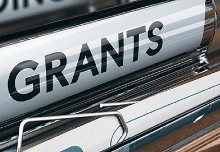 close up of a file folder with a grants label