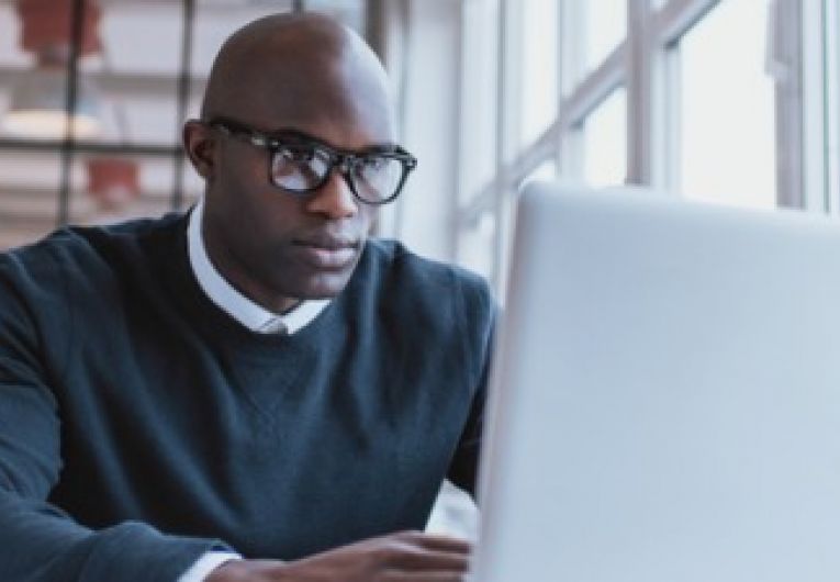 Businessman working on his laptop in an office