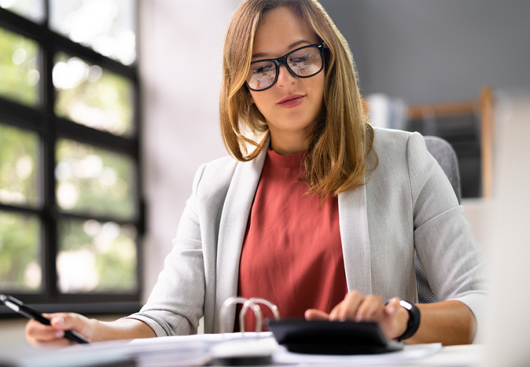 Accountant Women At Desk Using Calculator For Accounting