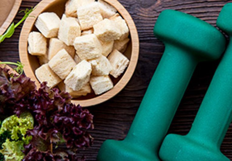 Work equipment and healthy food items on a table.