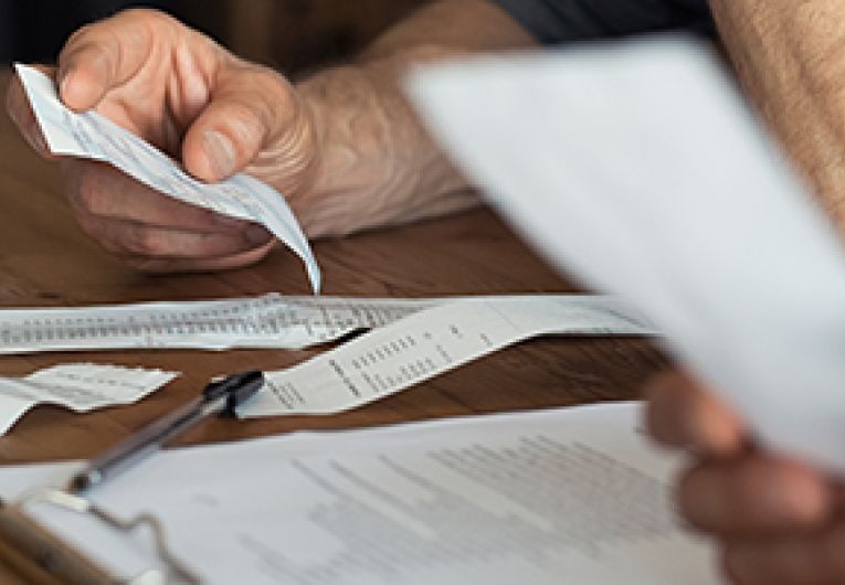 Small business owners look over invoices and receipts.