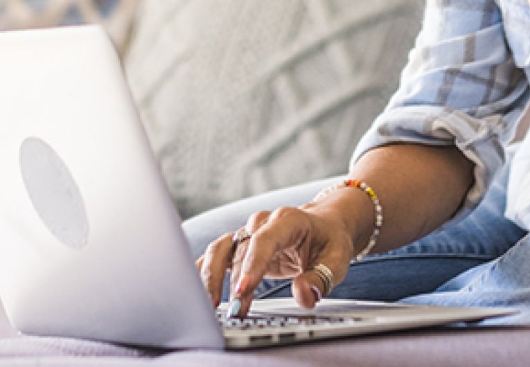 A person typing on a laptop.