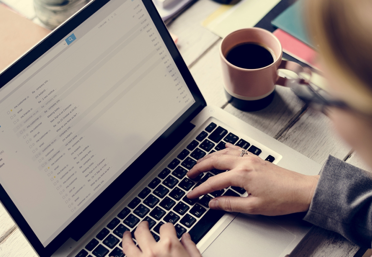 Businesswoman Checking E-mail Online on Laptop