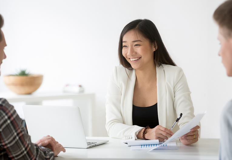 Female HR manager discussing employment benefits with two male employees