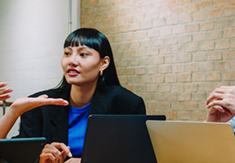 A group of business professionals having a discussion at a table.