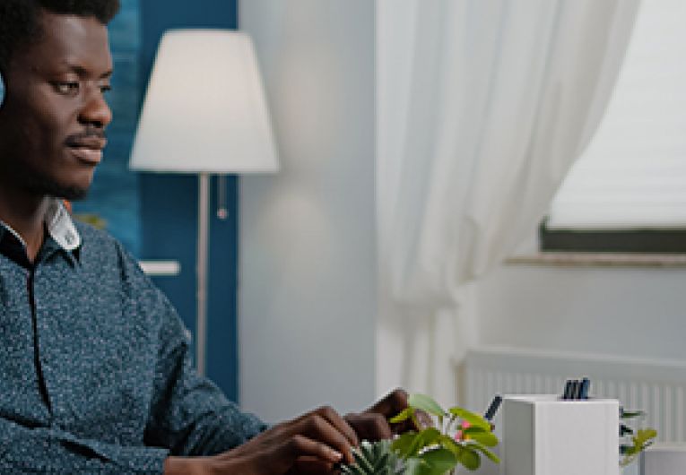 Employee working remotely at a desk in a home office.