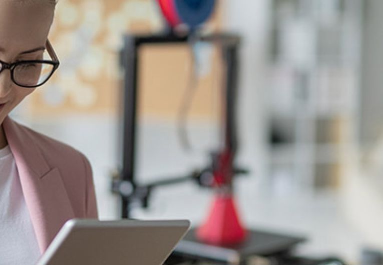 woman looking at tablet while in the office