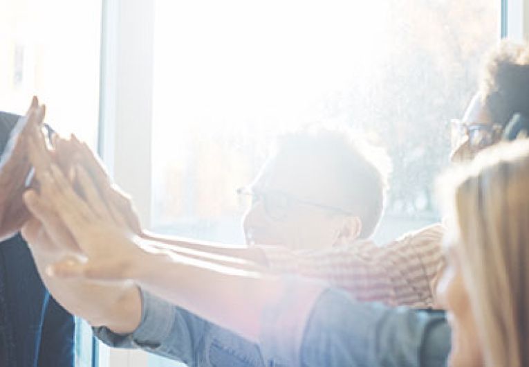 group of people high-fiving each other