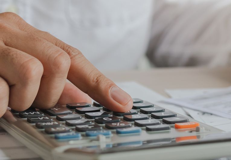 business person using calculator and pen