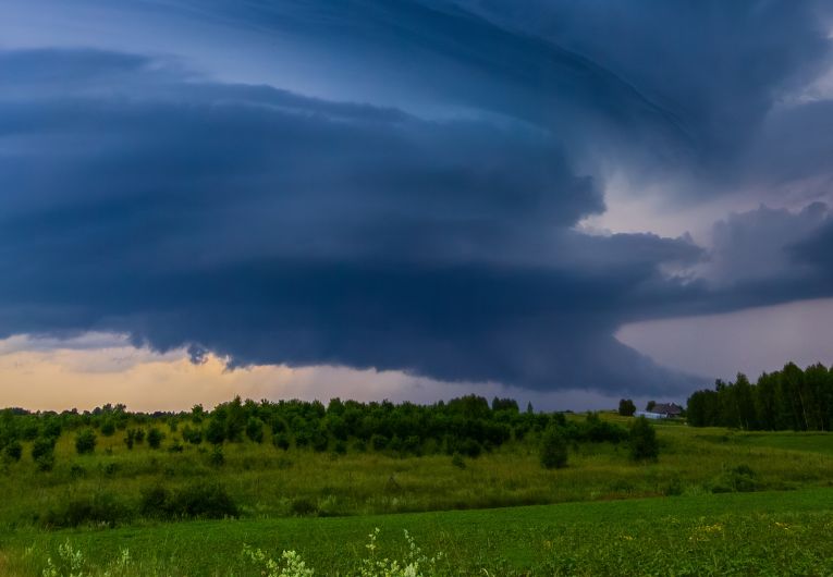 storm clouds rolling in over field 