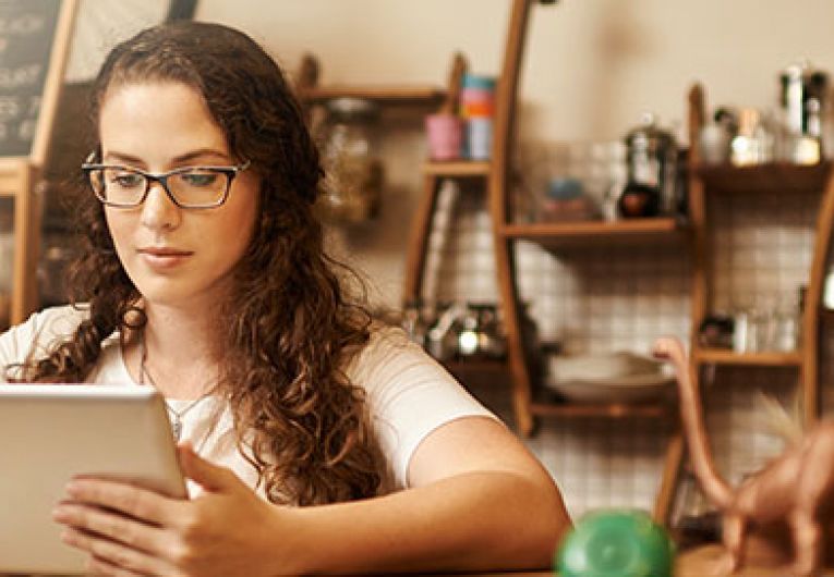 woman looking at tablet in store