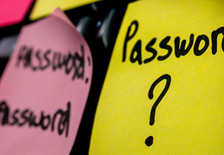 close up of a post-it not that has password? written on it