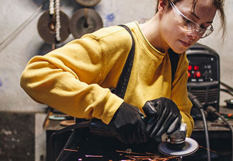 female metal worker in workshop