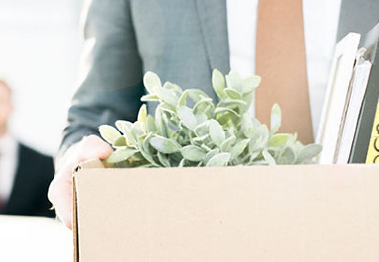 closeup of a man carrying a box