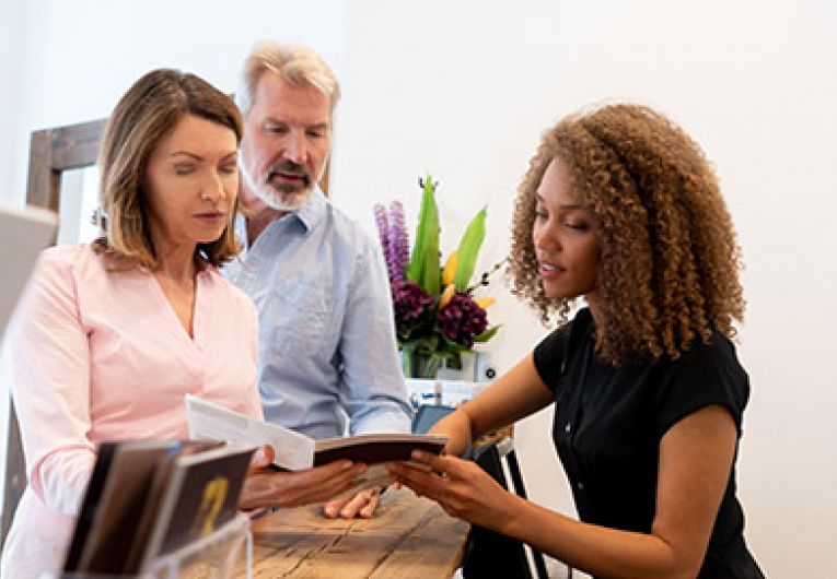 woman discussing something with a couple