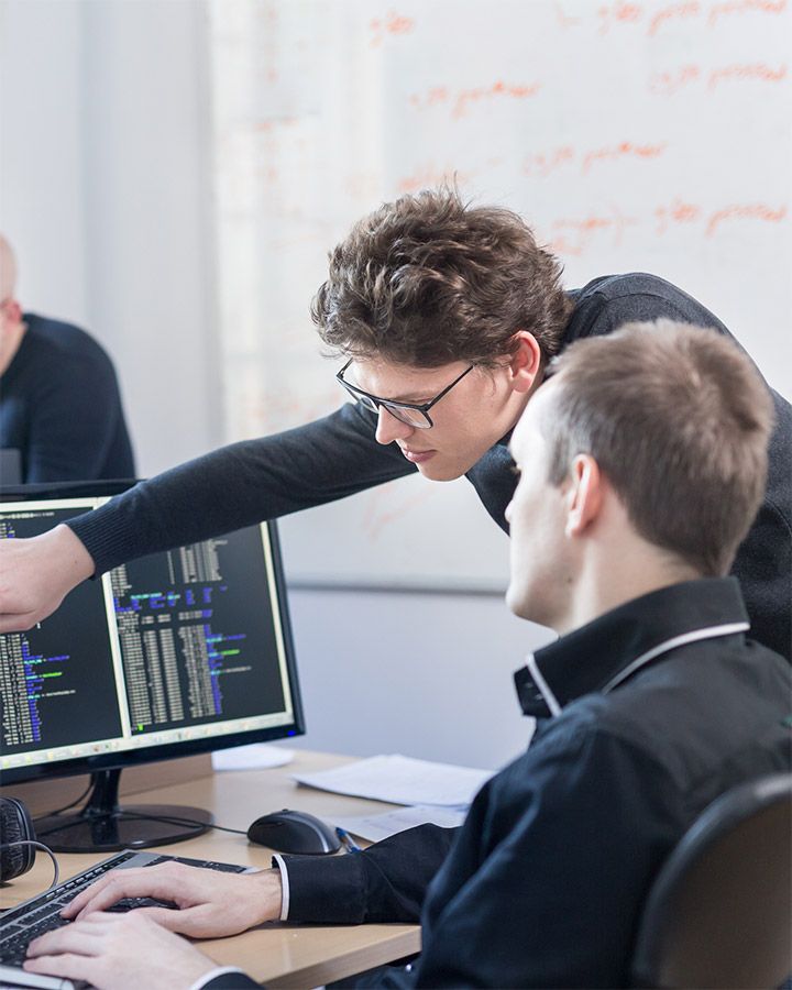 coworkers discussing something on a screen