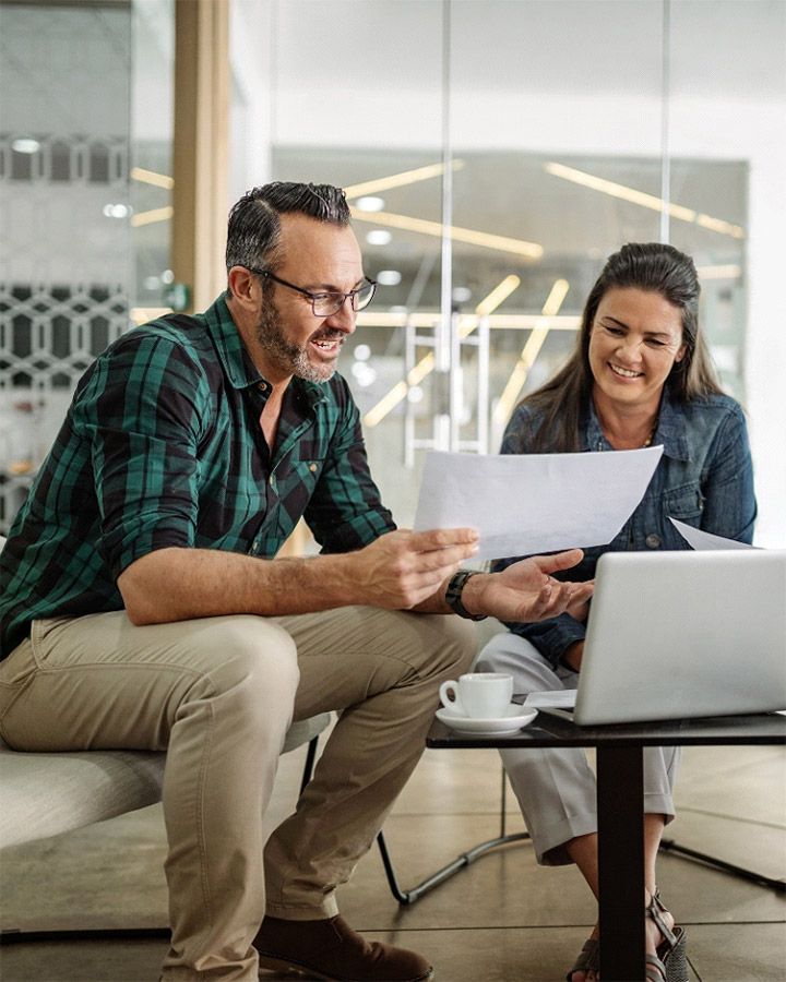 man and woman looking at some papers