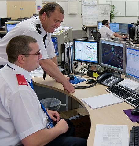 two men discussing something in an operations center