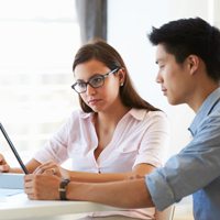 two business people looking at a computer