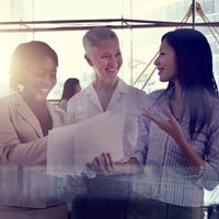 business employees talking over papers