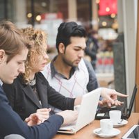 A group of people working together on their computers.