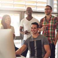 A group of people interacting with a computer.