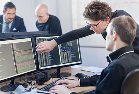 woman and man discussing something on a computer screen