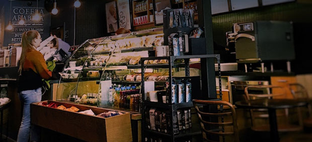 Woman working at a coffee shop bakery counter